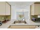Kitchen sink overlooking the backyard through a large sliding glass door in this sunny space at 1944 Hastings Ln, Clearwater, FL 33763