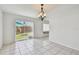 Bright living room features sliding glass doors to backyard and tile flooring throughout at 1944 Hastings Ln, Clearwater, FL 33763