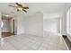 Spacious living room featuring tile floors, a ceiling fan, and access to other living spaces at 1944 Hastings Ln, Clearwater, FL 33763