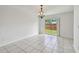Bright living room features sliding glass doors to backyard and tile flooring throughout at 1944 Hastings Ln, Clearwater, FL 33763