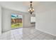 Bright living room features sliding glass doors to backyard and tile flooring throughout at 1944 Hastings Ln, Clearwater, FL 33763