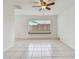 Bright living room with tiled floors, ceiling fan, and natural light at 1944 Hastings Ln, Clearwater, FL 33763