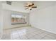 Bright living room with tiled floors, ceiling fan, and natural light at 1944 Hastings Ln, Clearwater, FL 33763