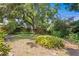 Lush backyard with mature trees and plantings provides a serene and private outdoor space, perfect for relaxing and entertaining at 2136 Cunningham Dr, Clearwater, FL 33763