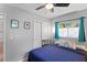 Comfortable bedroom boasts natural lighting, hardwood floors, and a ceiling fan at 2136 Cunningham Dr, Clearwater, FL 33763