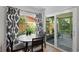 Dining area adjacent to the kitchen with table and chairs, plus a sliding glass door to the screened patio at 2136 Cunningham Dr, Clearwater, FL 33763