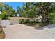 Charming single-story home with a well-manicured lawn, a driveway, and mature trees enhancing its curb appeal at 2136 Cunningham Dr, Clearwater, FL 33763