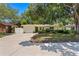 Charming single-story home with a well-maintained lawn, mature trees, and a welcoming front entrance, showcasing curb appeal at 2136 Cunningham Dr, Clearwater, FL 33763