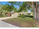 Well-maintained single-Gathering home with a lovely front lawn, mature trees, and a welcoming entrance, offering great curb appeal at 2136 Cunningham Dr, Clearwater, FL 33763