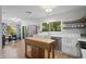 Modern kitchen with white cabinets, stainless steel appliances, a kitchen island, and adjacent dining area at 2136 Cunningham Dr, Clearwater, FL 33763