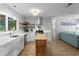 Bright, modern kitchen features white cabinets, stainless steel appliances, and an island with butcher block top at 2136 Cunningham Dr, Clearwater, FL 33763