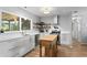 Modern kitchen with white cabinets, stainless steel appliances, a kitchen island, and hardwood floors at 2136 Cunningham Dr, Clearwater, FL 33763
