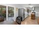 Bright kitchen featuring stainless steel appliances, light wood floors, and convenient access to the screened-in porch at 2136 Cunningham Dr, Clearwater, FL 33763