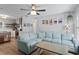 Open living room features a comfortable blue sectional couch and an open floorplan connected to the kitchen at 2136 Cunningham Dr, Clearwater, FL 33763