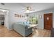 Bright living room features a large window overlooking the yard, a blue sectional couch, and hardwood floors at 2136 Cunningham Dr, Clearwater, FL 33763