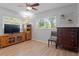 Living room featuring hardwood floors, natural lighting, and a wood entertainment center at 2136 Cunningham Dr, Clearwater, FL 33763