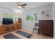 Living room featuring hardwood floors, natural lighting, and exercise accessories at 2136 Cunningham Dr, Clearwater, FL 33763