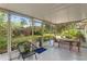 Open screened-in patio featuring multiple seating options with views of the flourishing yard at 2136 Cunningham Dr, Clearwater, FL 33763