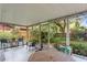 Relaxing screened-in patio featuring a combination of outdoor seating and views of the green backyard at 2136 Cunningham Dr, Clearwater, FL 33763
