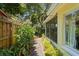 The side yard features lush greenery providing privacy and a tranquil outdoor space by a screened porch at 2136 Cunningham Dr, Clearwater, FL 33763