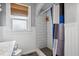 Clean bathroom with tiled shower featuring subway tiles, gray hex tile flooring, and window at 2723 8Th N Ave, St Petersburg, FL 33713