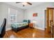 Cozy bedroom features hardwood floors, ceiling fan and bright natural light from the window at 2723 8Th N Ave, St Petersburg, FL 33713