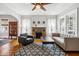 Bright living room with brick fireplace, ceiling fan, and hardwood floors at 2723 8Th N Ave, St Petersburg, FL 33713