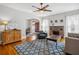 Bright living room with brick fireplace, ceiling fan, and hardwood floors at 2723 8Th N Ave, St Petersburg, FL 33713