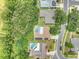 Aerial view of homes featuring a screened-in pool, and mature trees in a desirable neighborhood at 313 Oak Crest Dr, Safety Harbor, FL 34695