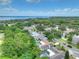Scenic aerial view of a residential neighborhood with lush greenery and glimpses of the bay, offering a serene living environment at 313 Oak Crest Dr, Safety Harbor, FL 34695