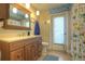 Bathroom vanity with hard surface counter, hanging lights, and sea themed decor at 313 Oak Crest Dr, Safety Harbor, FL 34695
