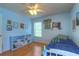 Light blue bedroom featuring a bookcase, hardwood floors, and bright window at 313 Oak Crest Dr, Safety Harbor, FL 34695