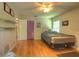 Well-lit bedroom featuring a ceiling fan, wood floors, and large window at 313 Oak Crest Dr, Safety Harbor, FL 34695