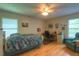 Bedroom featuring a ceiling fan, window, hardwood floors, and work desk at 313 Oak Crest Dr, Safety Harbor, FL 34695