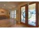 Bright entryway featuring decorative glass doors and a view into the living area with large windows, creating an airy feel at 313 Oak Crest Dr, Safety Harbor, FL 34695