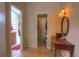 Hallway with access to the bathroom, closet, and vanity area with tile flooring at 313 Oak Crest Dr, Safety Harbor, FL 34695