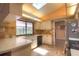 Bright kitchen features a window over the sink, light cabinets, and decorative backsplash and countertops at 313 Oak Crest Dr, Safety Harbor, FL 34695