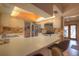 Kitchen with white countertops, wood cabinets, stainless steel appliances, breakfast bar, and decorative backsplash at 313 Oak Crest Dr, Safety Harbor, FL 34695
