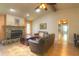 Cozy living room boasts a stone fireplace, wood-beamed ceiling, and tile flooring, perfect for relaxing and entertaining at 313 Oak Crest Dr, Safety Harbor, FL 34695