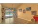 Living room features sliding glass doors out to the pool, and artwork on the tan colored walls at 313 Oak Crest Dr, Safety Harbor, FL 34695