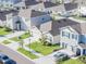 An aerial view showcases a well-kept community, street appeal, and a lush landscape at 33488 Elm Hill Br, Wesley Chapel, FL 33545