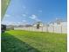 Expansive backyard featuring a large, well-kept lawn and privacy fence at 33488 Elm Hill Br, Wesley Chapel, FL 33545