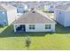 Aerial view of backyard with a green lawn and covered patio area at 33488 Elm Hill Br, Wesley Chapel, FL 33545