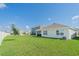Lush backyard featuring a covered patio and ample space for recreation, perfect for Gathering gatherings at 33488 Elm Hill Br, Wesley Chapel, FL 33545