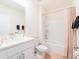 Well-lit bathroom featuring a combined shower and bathtub, white marble vanity, and neutral accents at 33488 Elm Hill Br, Wesley Chapel, FL 33545