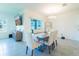 Bright dining room area features a modern table, view of the backyard, and contemporary design at 33488 Elm Hill Br, Wesley Chapel, FL 33545