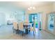 Elegant dining space featuring a modern chandelier, neutral walls, and a sliding glass door to the patio at 33488 Elm Hill Br, Wesley Chapel, FL 33545