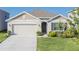 Charming single-story home with a well-manicured lawn and attached two-car garage at 33488 Elm Hill Br, Wesley Chapel, FL 33545