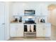 Stylish kitchen featuring stainless steel appliances, granite countertops, and white cabinetry at 33488 Elm Hill Br, Wesley Chapel, FL 33545