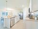 Bright kitchen features stainless appliances, an island with stone countertops, and a breakfast bar at 33488 Elm Hill Br, Wesley Chapel, FL 33545
